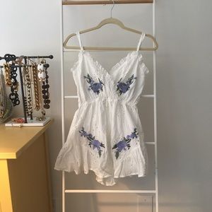 White romper with purple embroidery